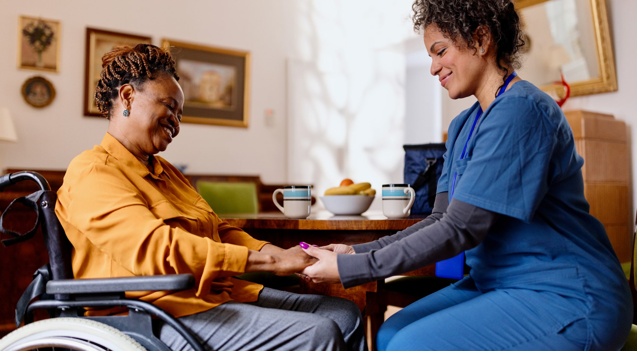 Healthcare worker helping a patient at home